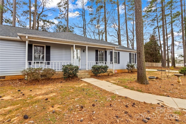 ranch-style home with crawl space, covered porch, and a shingled roof