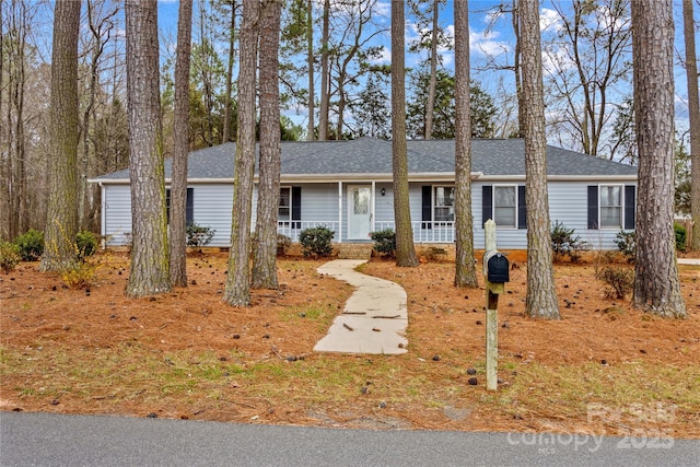 ranch-style home featuring a porch and a shingled roof