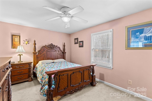 bedroom featuring baseboards, light carpet, and a ceiling fan