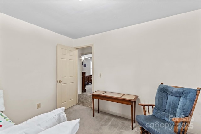 sitting room featuring light carpet