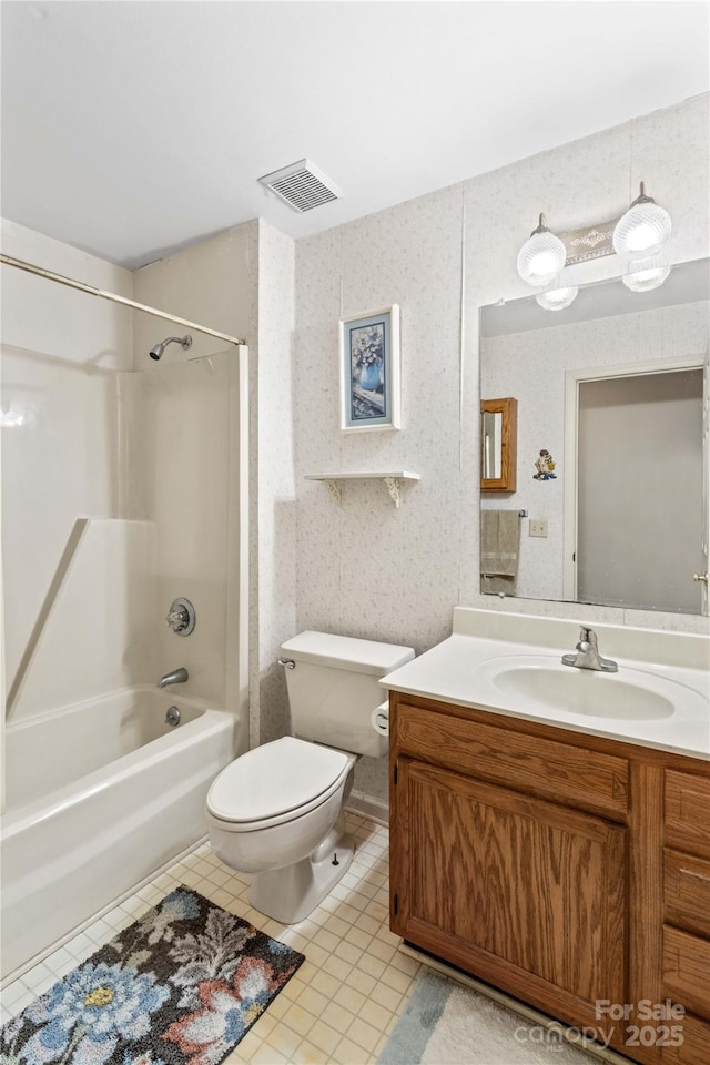 bathroom featuring tile patterned floors, visible vents, toilet, washtub / shower combination, and vanity