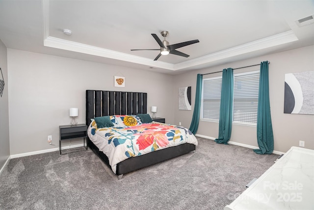 carpeted bedroom featuring a tray ceiling, baseboards, visible vents, and ornamental molding