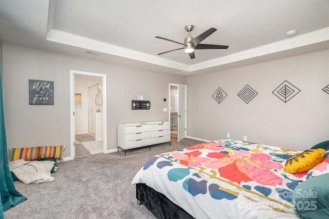 carpeted bedroom with a tray ceiling, baseboards, visible vents, and ornamental molding