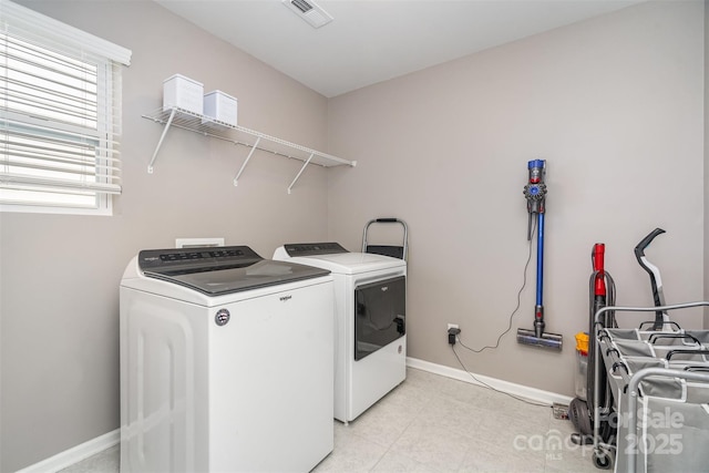 laundry area with visible vents, baseboards, separate washer and dryer, and laundry area