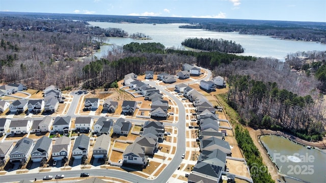 bird's eye view with a residential view, a water view, and a view of trees