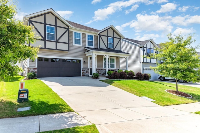 19113 Hawk Haven Ln, Charlotte, NC 28278 - english style home with an attached garage, a front lawn, concrete driveway, and stone siding