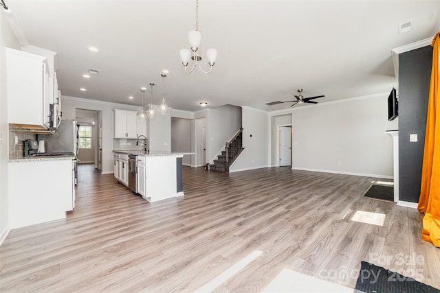 19113 Hawk Haven Ln, Charlotte, NC 28278 - kitchen with stainless steel dishwasher, open floor plan, crown molding, a ceiling fan, and a chandelier