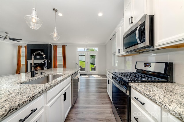 19113 Hawk Haven Ln, Charlotte, NC 28278 - kitchen featuring appliances with stainless steel finishes, tasteful backsplash, dark wood-style flooring, white cabinets, and recessed lighting