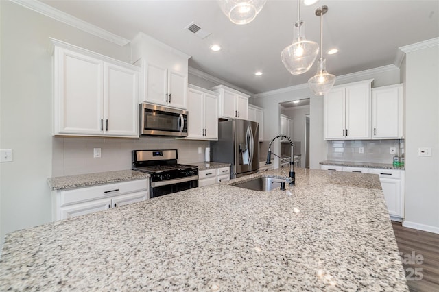 19113 Hawk Haven Ln, Charlotte, NC 28278 - kitchen featuring appliances with stainless steel finishes, white cabinetry, decorative backsplash, crown molding, and light stone countertops