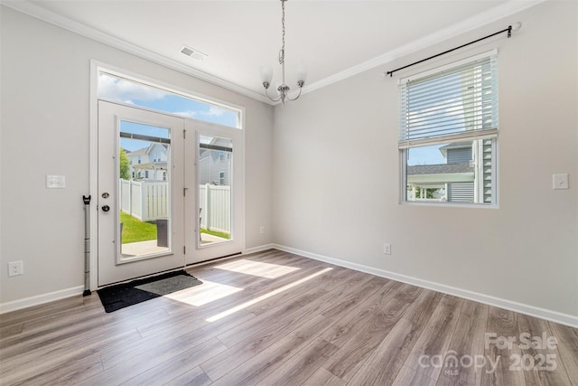 19113 Hawk Haven Ln, Charlotte, NC 28278 - empty room with ornamental molding, wood finished floors, and a chandelier