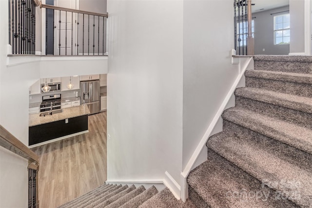 19113 Hawk Haven Ln, Charlotte, NC 28278 - stairs with wood finished floors and baseboards