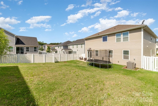19113 Hawk Haven Ln, Charlotte, NC 28278 - back of house featuring a trampoline, a fenced backyard, and a residential view