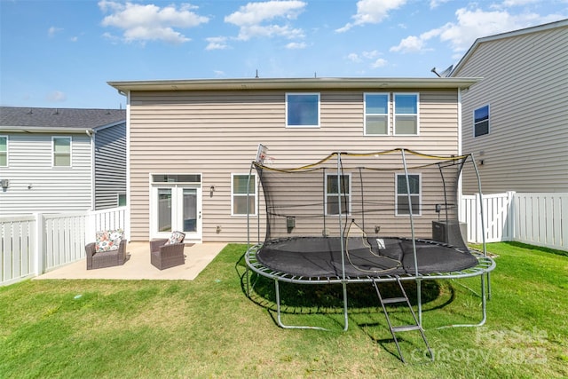 19113 Hawk Haven Ln, Charlotte, NC 28278 - rear view of property with a trampoline, a patio area, and a fenced backyard