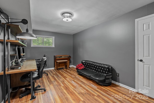 home office with baseboards and light wood finished floors