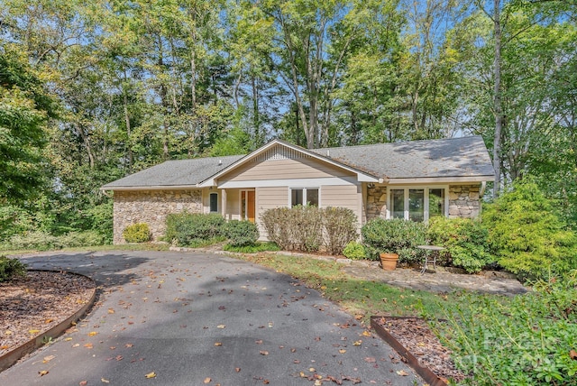 single story home featuring stone siding