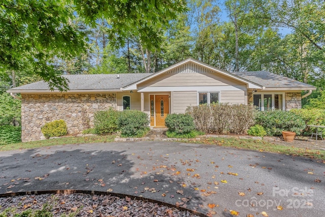 ranch-style home with stone siding