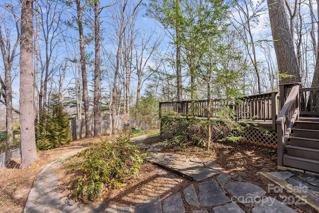 view of yard with fence and a deck