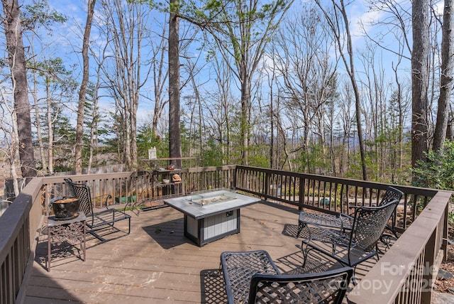 wooden deck with a fire pit