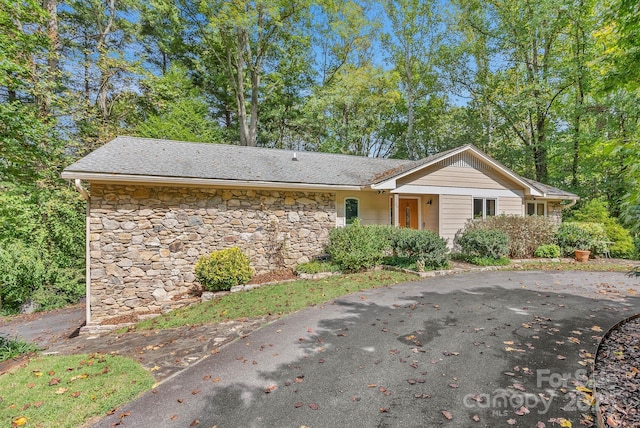 ranch-style house with stone siding