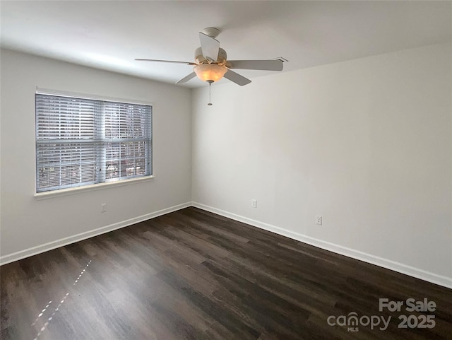 spare room featuring ceiling fan, wood finished floors, and baseboards