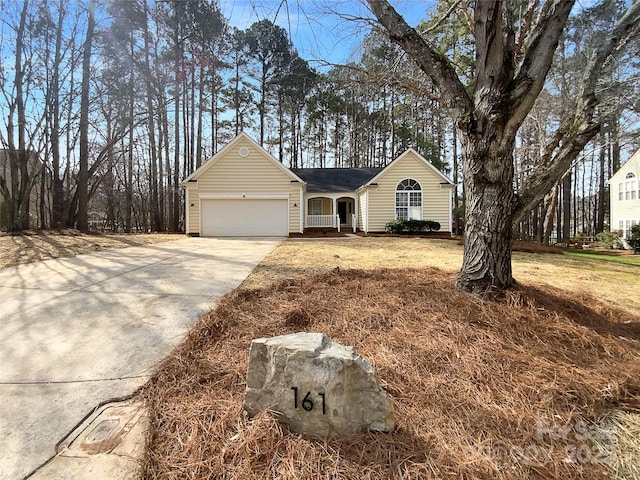 ranch-style house featuring a garage, driveway, and a front lawn