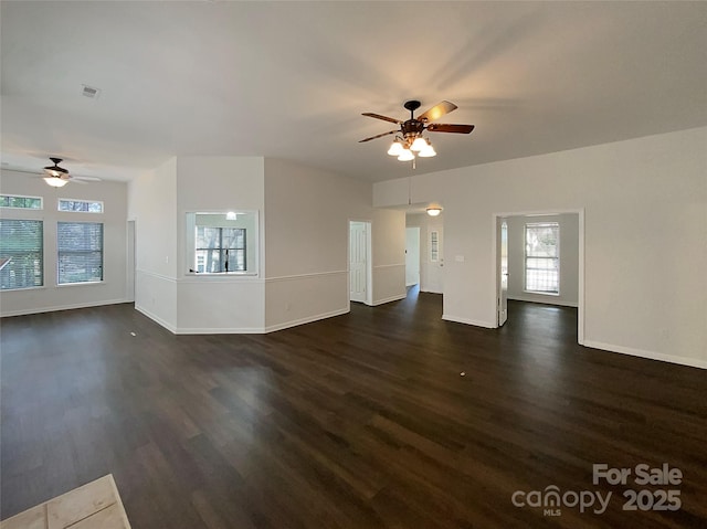 unfurnished living room with ceiling fan, baseboards, visible vents, and dark wood finished floors