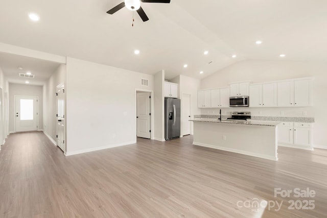 kitchen featuring stainless steel appliances, visible vents, and light wood-style flooring