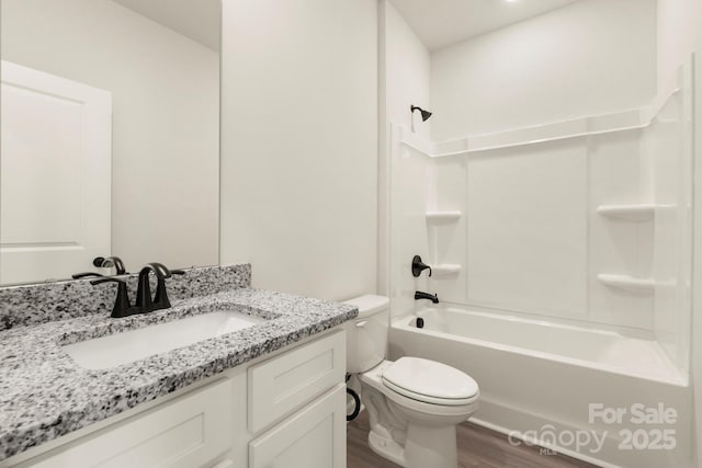 bathroom featuring  shower combination, vanity, toilet, and wood finished floors