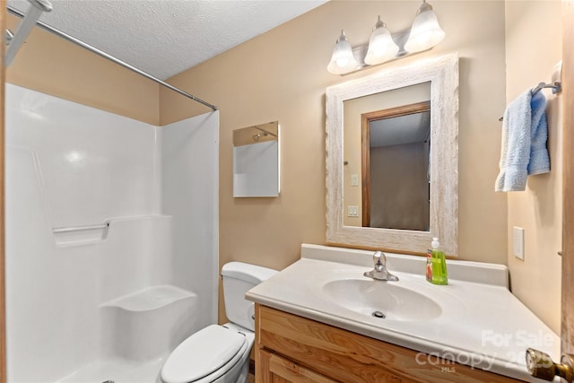 bathroom featuring a shower, a textured ceiling, toilet, and vanity