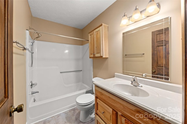 bathroom featuring toilet, bathtub / shower combination, a textured ceiling, and vanity