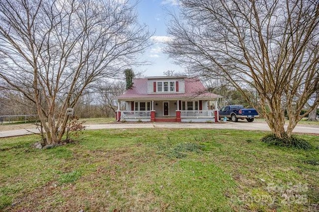 view of front of home featuring covered porch and a front yard