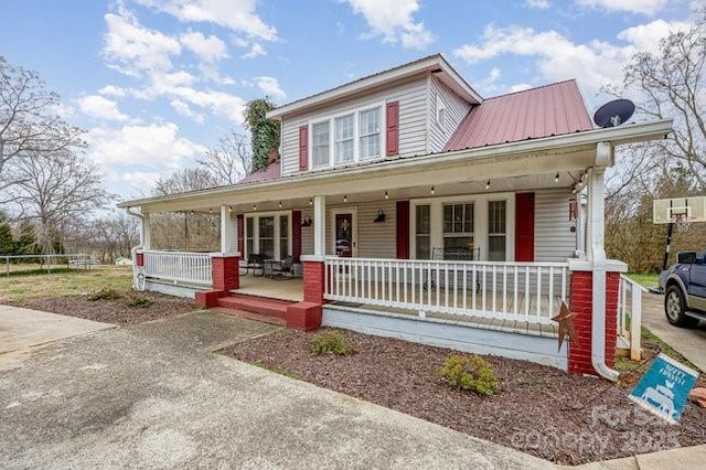 view of front of home featuring a porch and metal roof