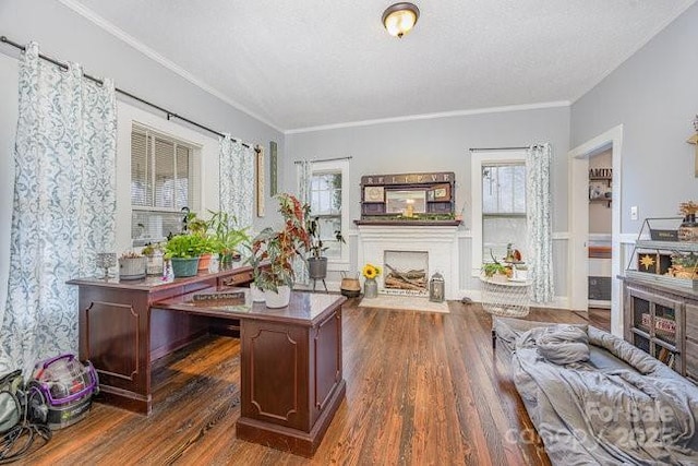 home office featuring crown molding, a fireplace with flush hearth, wood finished floors, and a textured ceiling