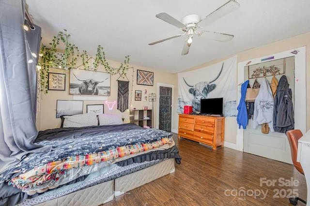 bedroom with wood finished floors and a ceiling fan