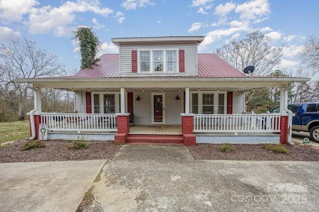 view of front facade featuring covered porch and metal roof