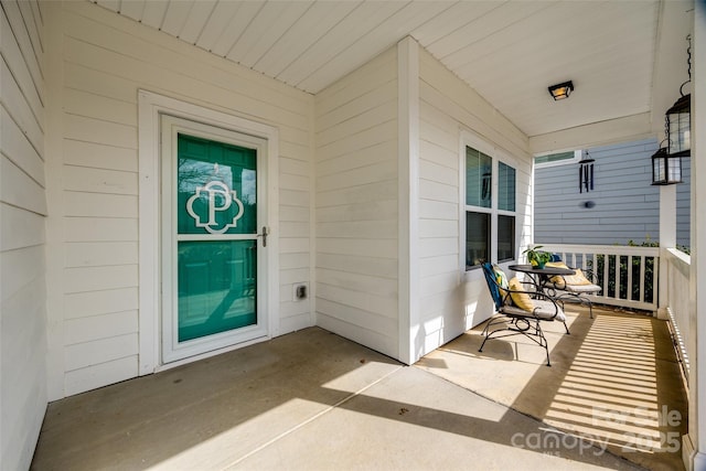 view of exterior entry with covered porch