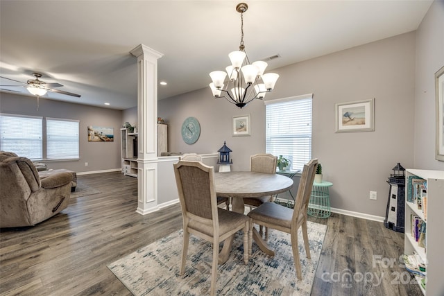 dining room with dark wood finished floors, a healthy amount of sunlight, and decorative columns