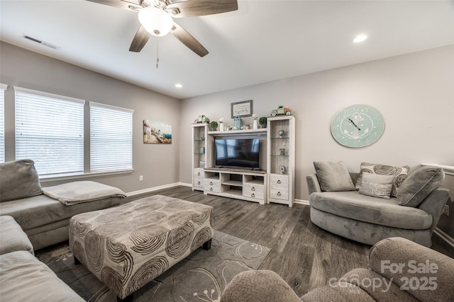 living area with dark wood-type flooring, recessed lighting, visible vents, and baseboards