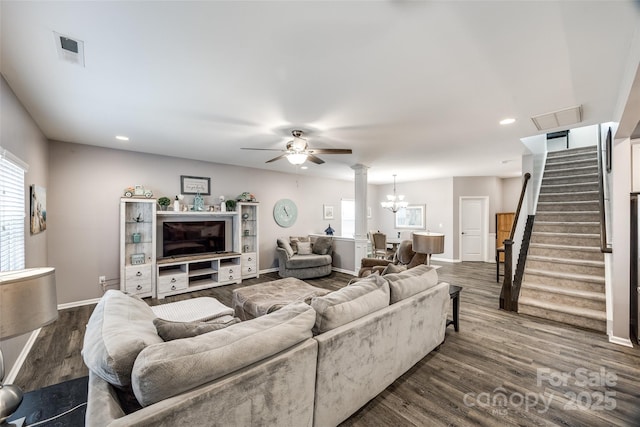 living area with visible vents, stairway, dark wood finished floors, and baseboards