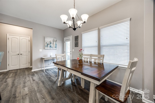 dining area with a chandelier, baseboards, and wood finished floors