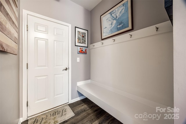 mudroom with dark wood-style floors and baseboards