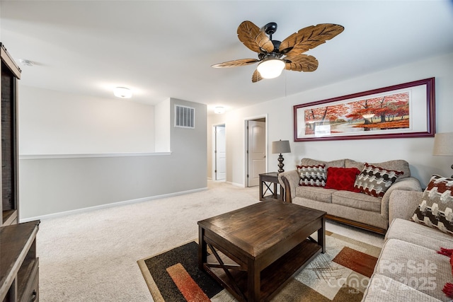 living area featuring light colored carpet, visible vents, ceiling fan, and baseboards