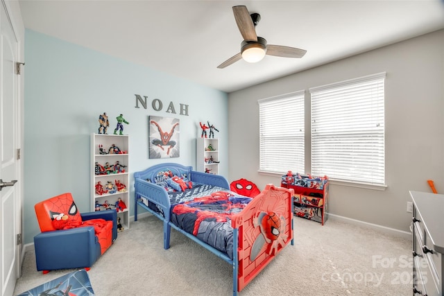 bedroom with a ceiling fan, carpet flooring, and baseboards