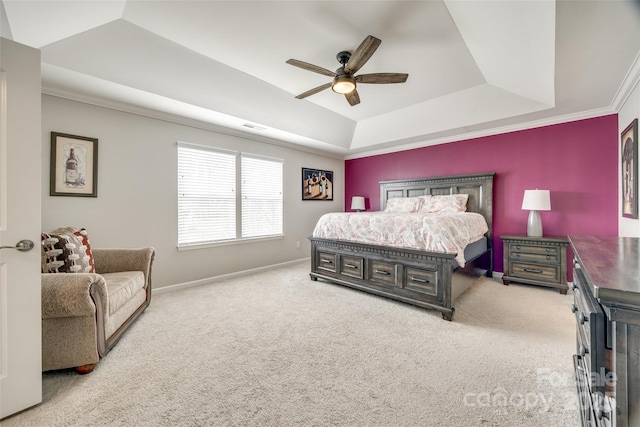 bedroom featuring carpet, a raised ceiling, a ceiling fan, and baseboards