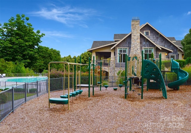 community play area with fence and a community pool