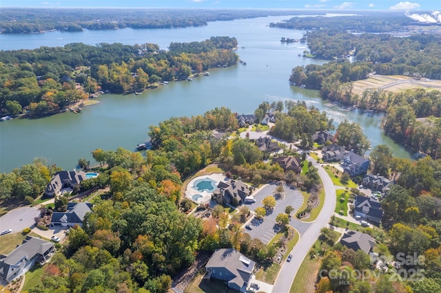 birds eye view of property featuring a water view, a residential view, and a wooded view