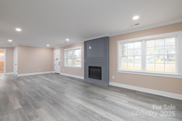 unfurnished living room with ornamental molding, visible vents, a fireplace, and baseboards