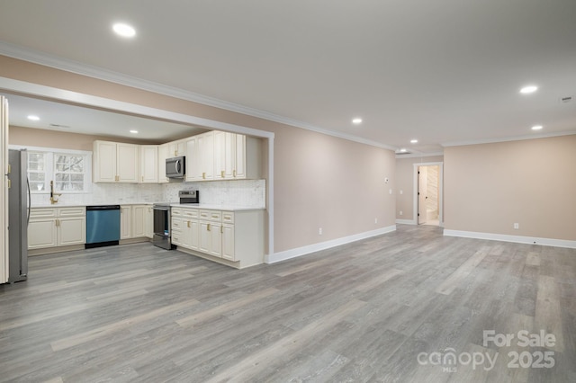 kitchen featuring light wood finished floors, baseboards, stainless steel appliances, and backsplash