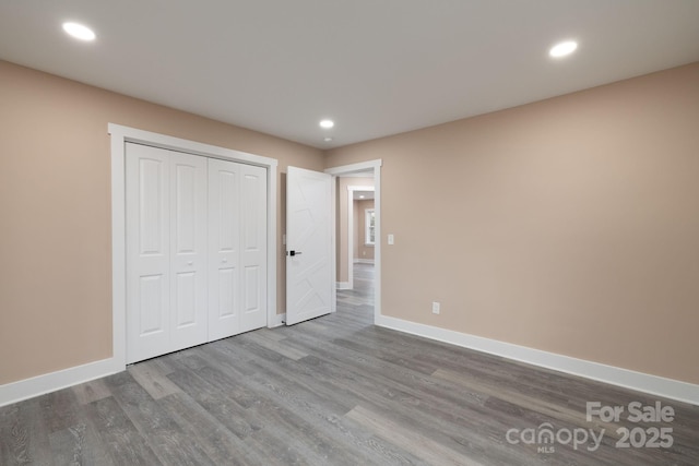 unfurnished bedroom featuring recessed lighting, baseboards, and wood finished floors