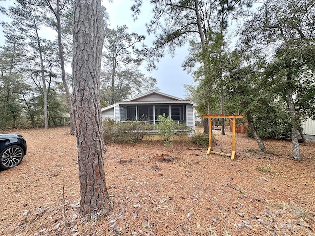 view of front of home featuring a sunroom